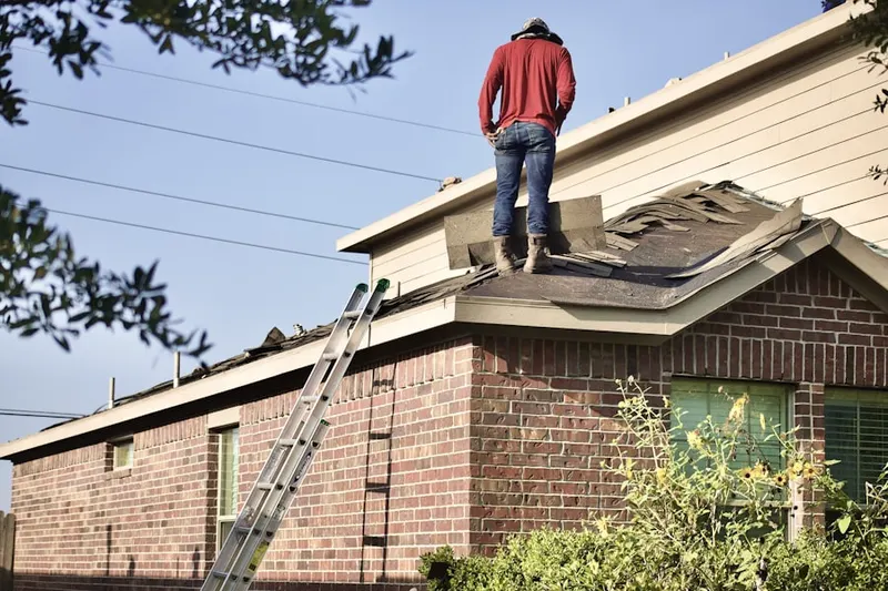 Professional roofer working on a residential roof in Spring Brook Plant